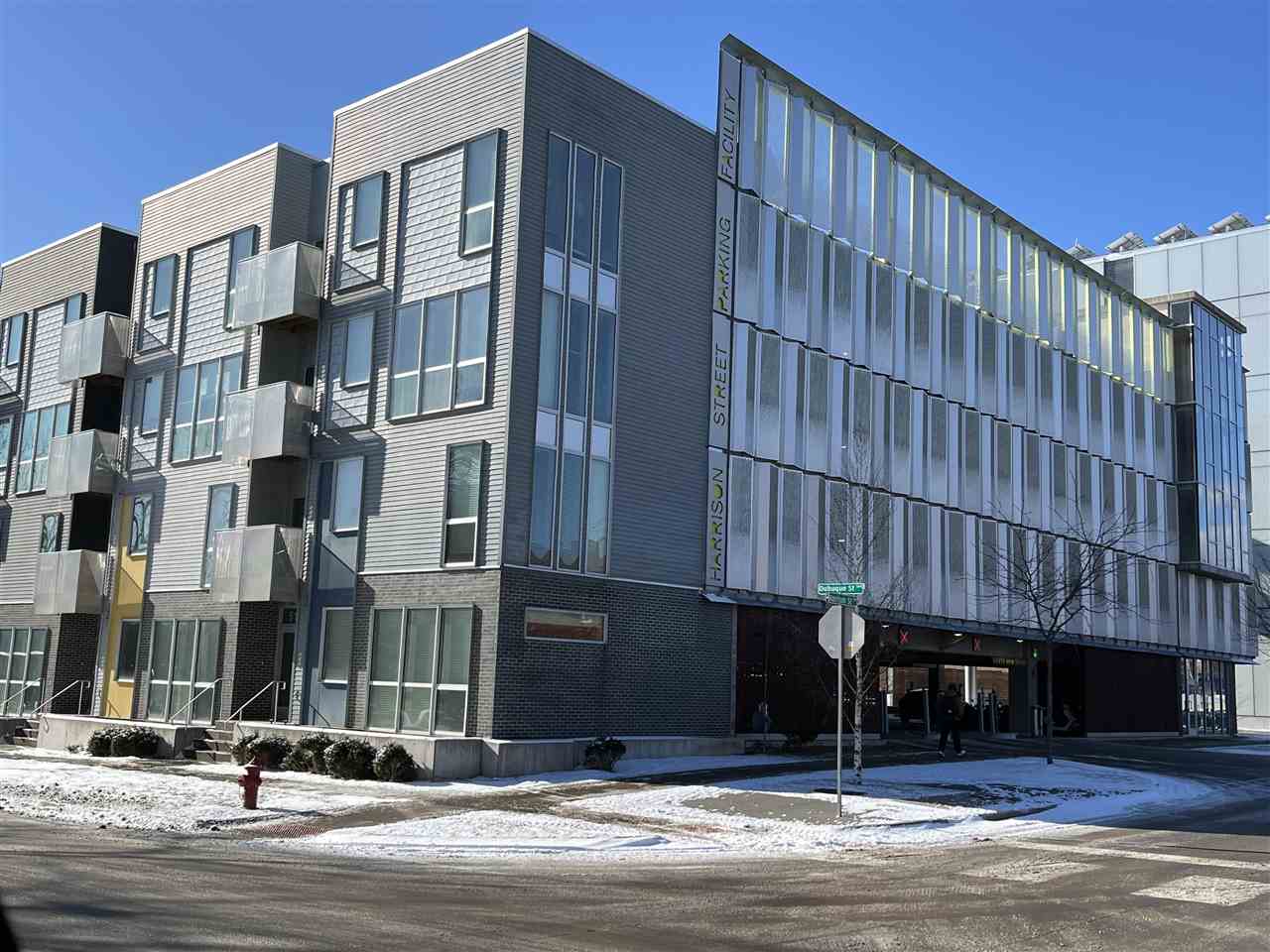 Sharp two story townhome with direct access to S. Dubuque St.  Easy walk to downtown and campus.  End unit on corner of building.  Open floorplan, spacious windows providing lots of natural lighting.  Large kitchen island and breakfast bar has Corian countertop, stainless kitchen appliances included.  LVP flooring on main level, carpet up.  First floor half bath.  Second floor has 2 bedrooms, one balcony, hall laundry with stack washer/dryer, ¾ bath.  Two reserved parking spaces available with City of Iowa City in Harrison Street ramp, conveniently just outside the back door, $90.00 per month per space. Leased to August 2, 2025, need 24 hour notice to show.  Showings must be between 10:00am-6:00pm weekdays, no Saturday showings, Sunday between 1:00pm - 5:00pm.  Text listing agent to show.