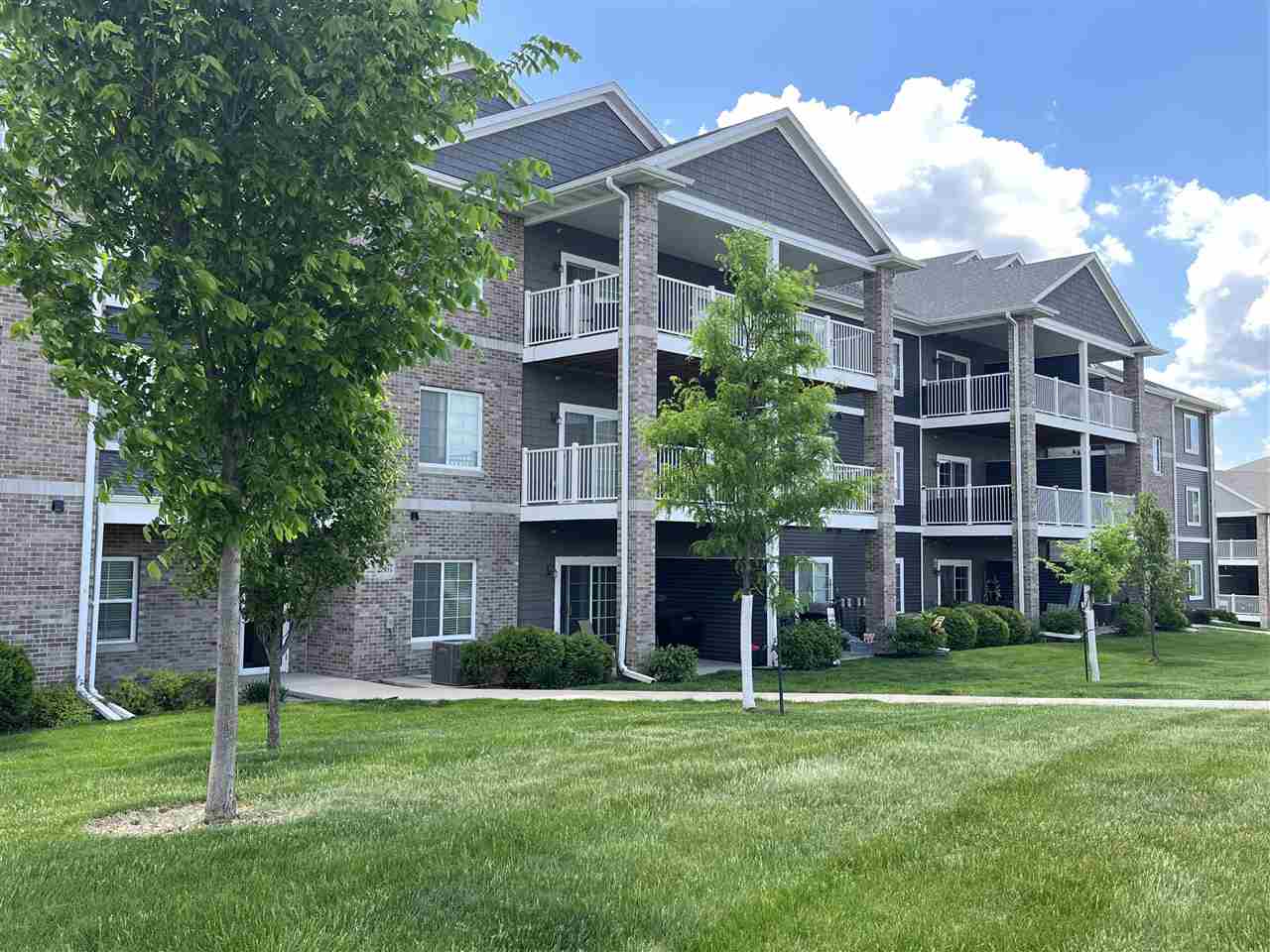 Immaculate, like new top floor condo.  Excellent location has private deck with views of greenery, woods, and a gazebo.  One bedroom, one full bath.  Open floor plan, high ceilings.  Kitchen has ample cabinetry, hard surface counters, large island with breakfast bar, appliances included.  LVP flooring from kitchen through living room and bath.  Living room has corner fireplace and sliding door to the private deck.  Spacious bedroom with walk in closet.  Laundry room with washer and dryer included.  Furnace/water heater room located outside unit in hallway.  Building has secure entrance doors, secure underground parking garage with remote opener, elevator, and ample guest parking space.  Conveniently located near Interstates 80 and 380.  Close to bike and walking trails, lots of shopping and restaurants.  Ready to move in and enjoy.