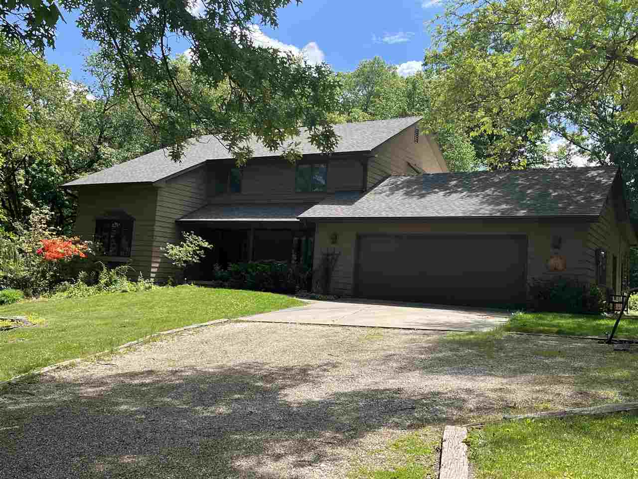 Spacious two story located at end of quiet cul de sac, close in yet very private, just  minutes to downtown IC. This original owner home sits on approx. 2.34  acres of woods and open yard, orchard area and amazing plantings, as pretty as you will find. Backs to Army Corp land, even has a tennis court. 4 bedrooms up, 3.5 baths. Spacious first floor family room has pretty built ins, fireplace, opens to deck. Formal living and dining rooms. Kitchen has dining area, hard surface counters, ample cabinetry, plus pantry closet, appliances included. Lovely wood flooring on main level, tile in baths, carpet in bedrooms. Amazing views from all windows. Six panel doors. Screen porch and deck. Primary suite has full bath, walk in closet. Second floor hallway laundry, washer/dryer included. Walk out lower level has huge family room, woodburning stove, ¾ bath, shop/storage room. Close to schools, bike path, reservoir, and interstate.