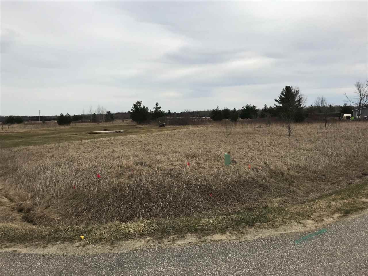 Nice level lot with no clearing required.  Plant trees where you want them. Lot is unimproved and waiting for your specs for camping or building.  Great walking/biking location and short distance to Lake Lancer.   You will be required by Butman Twp to connect to the Sewer system to Camp.  For details and costs, please contact the Sewer Dept 989-426-9955.   Ownership provides access to an 18 hole golf course , restaurant/pub, fitness center, indoor heated pool, tennis/bocce ball courts, chalet/sledding hill, walking (nature) trails, activity bldg, storage area, 2 all sports lakes, Lk Lancer/Lancelot, 15 beach clubs (5 with beach/bath house). Or fly to/from Sugar Springs off a 3500ft well maintained grass airpark.   www.airnav.com   5M6.    ALL just 2-1/2 hours from Detroit!