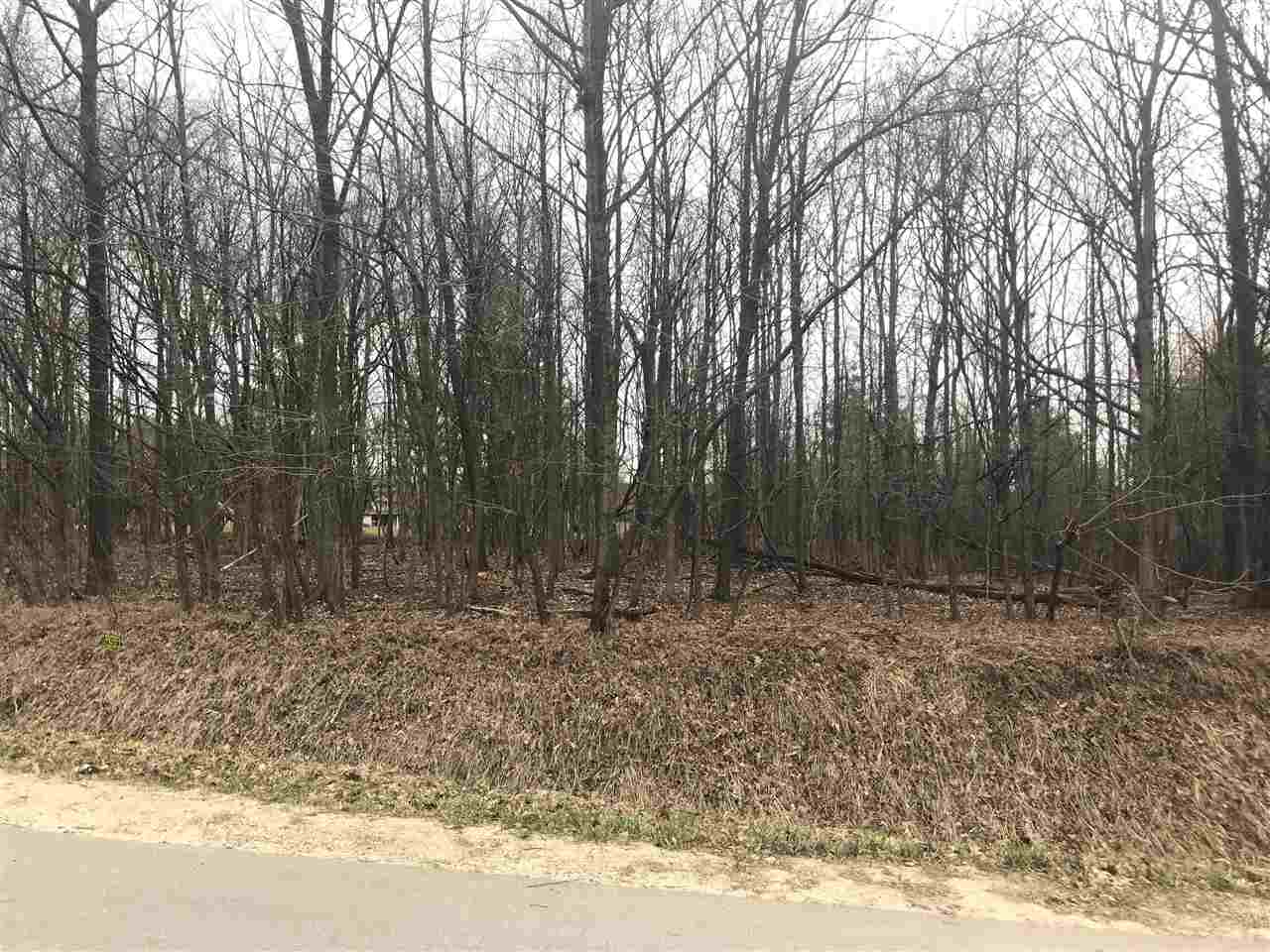 Beautiful location for building or camping.   Lot sits directly across from an 18-hole Golf Course, level and in an area of nice homes. Large road frontage for any size home.  Backs up to a large common area.  To camp, you will need to connect to the sewer system.  Call Butman Twp for cost and details  989-426-4351 M-W-F.   Ownership provides access to an 18 hole golf course , restaurant/pub, fitness center, indoor heated pool, tennis/bocce ball courts, chalet/sledding hill, walking (nature) trails, activity bldg, storage area, 2 all sports lakes, Lk Lancer/Lancelot, 15 beach clubs (5 with beach/bath house). Or fly to/from Sugar Springs off a 3500ft well maintained grass airpark.   www.airnav.com   5M6.    ALL just 2-1/2 hours from Detroit!