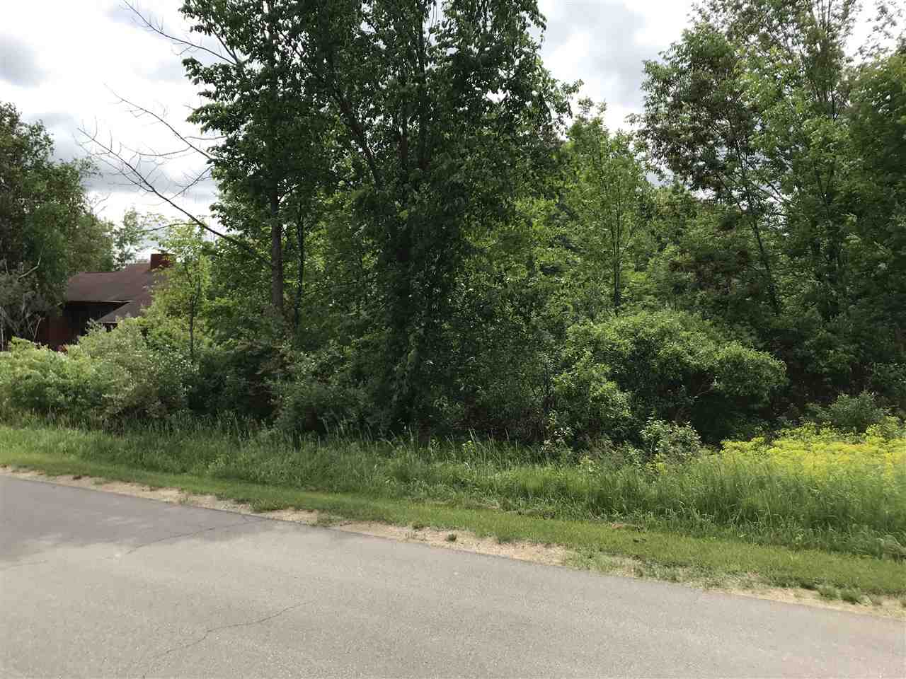 Unimproved lot across from Golf Course, in an area of nice homes.    Great location for camping or building. (You will need to connect to the sewer system to put camper on lot.     Ownership provides access to an 18 hole golf course , restaurant/pub, fitness center, indoor heated pool, tennis/bocce ball courts, chalet/sledding hill, walking (nature) trails, activity bldg, storage area, 2 all sports lakes, Lk Lancer/Lancelot, 15 beach clubs (5 with beach/bath house). Or fly to/from Sugar Springs off a 3500ft well maintained grass airpark.   www.airnav.com   5M6.    ALL just 2-1/2 hours from Detroit!