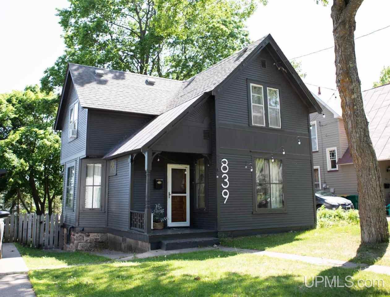 Here's your chance to own a beautiful historic home in the City of Marquette. Centrally located close to downtown, you are close to parks, shopping, restaurants and the food co-op. You'll appreciate this home's high ceilings, wood floors, and abundant natural light. The extra large living space also features a supplemental gas heating stove, perfect for creating a cozy environment during a Marquette winter. Upstairs you'll find all 4 bedrooms along with your laundry room. No more lugging baskets downstairs! The basement with half bath walks out to a huge fenced in yard making for easy access. Storage shed on the property houses a snowblower and lawn mower which are also included in the purchase! All that's left is for you to move in!
