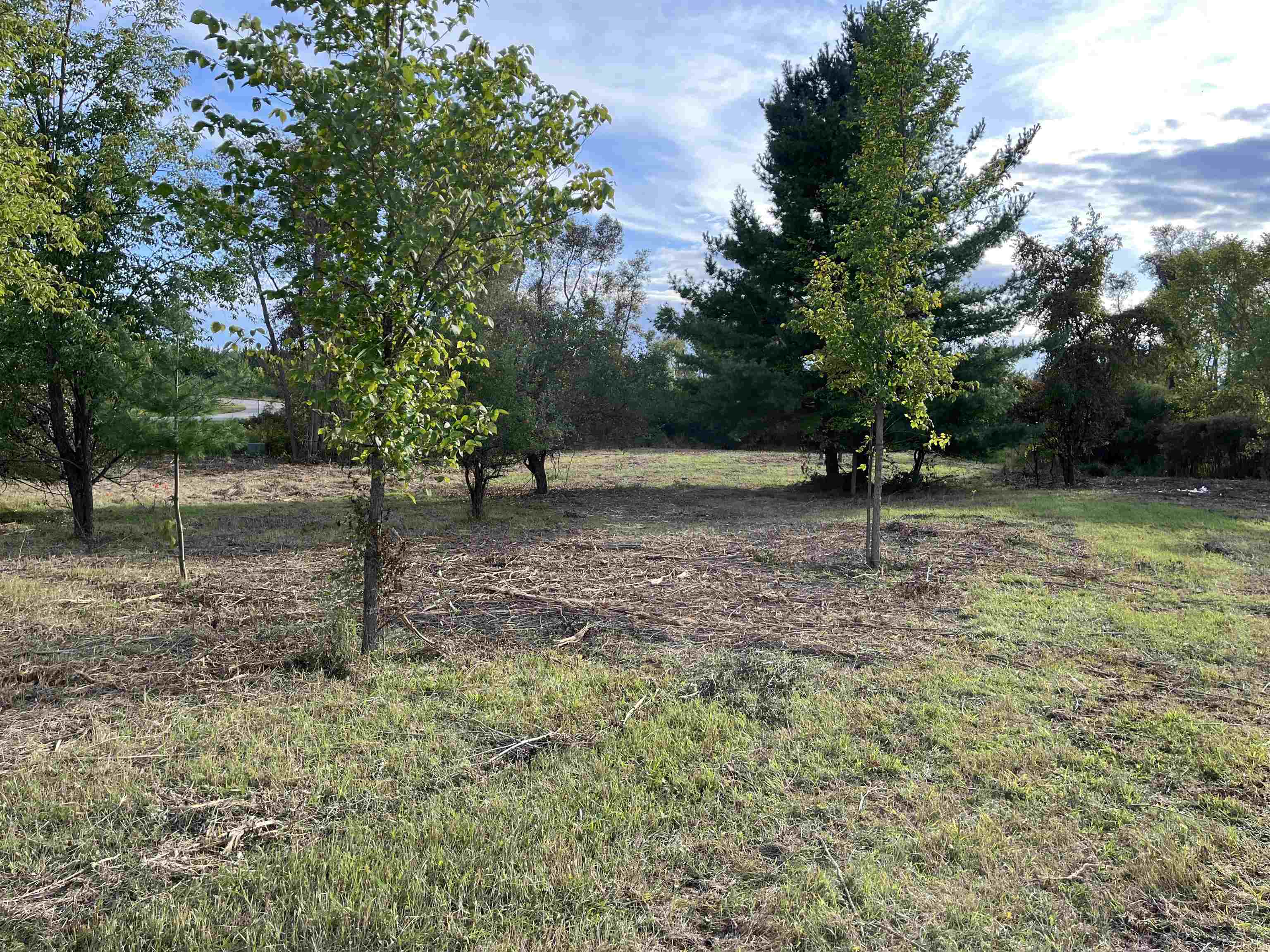 1.72 Acres to spread out on.  5 lots Overlooking rural area and beautiful landscape.   4 Contiguous lots and includes lot 84 equaling 1.72 acres ready for you to build or camp and giving you the whole west side of street and surrounded by commons for privacy.  Property has been clear (see photos) and there is a driveway and electric brought into lot, but will need to be brought up to code through Consumers.   Just a short walk to Kenworth Beach Club for rental docks or boat ramp.  FYI:  You will need to get a permit and connect to sewer for camping. Hamilton Realm is a great biking and walking location.    Ownership provides access to an 18 hole golf course , restaurant/pub, fitness center, indoor heated pool, tennis/bocce ball courts, chalet/sledding hill, walking (nature) trails, activity bldg, storage area, 2 all sports lakes, Lk Lancer/Lancelot, 15 beach clubs (5 with beach/bath house). Sugar Springs offer year around activities and events to enjoy.   2-1/2 hours from Detroit.