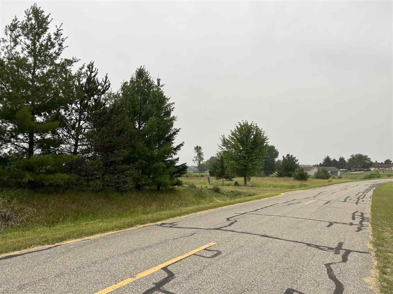 Great location and lots of land.    High and overlooks Hockaday and farm land and.  Lots has electric and driveway.  Lots are merged for one yearly POA Dues.   You will need to connect to sewer to camp, but this is an excellent place for building your home and room for a large garage.   Ownership provides access to an 18 hole golf course , restaurant/pub, fitness center, indoor heated pool, tennis/bocce ball courts, chalet/sledding hill, walking (nature) trails, activity bldg, storage area, 2 all sports lakes, Lk Lancer/Lancelot, 15 beach clubs (5 with beach/bath house). Or fly to/from Sugar Springs off a 3500ft well maintained grass airpark.   www.airnav.com   5M6.    ALL just 2-1/2 hours from Detroit!