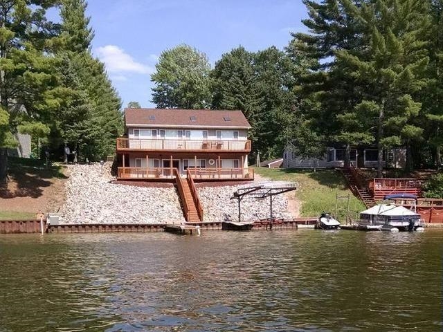 FUN IN THE SUN ON SECORD LAKE!  75 ft of Secord waterfront with all maintenance free landscaping.  4BD, 2BA ranch with custom oak doors and trim, main floor laundry, large kitchen with oak cabinets, lazy susan cabinets, easy pull out shelving, serving counter and plenty of windows with beautiful view of waterfront.  Lower level walk out is all set up for entertaining.  Wired for cable, excellent location for flat screen, includes wet bar, full bath, guest room and office/den/bedroom.  Professional landscaping, steel seawall with permanent dock, outdoor lighting and plenty of decking for great recreational fun.  Attached 2.5 heated garage and 30x40 polebarn which has concrete floors, 220 amp service.  House is also wired for a generator.  See Lake/Dam Disclosure for Lake Level information.  Just 2.5 hours from Metro Detroit Area which makes a weekend trip easy.
