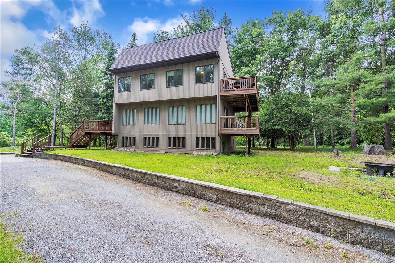 You get the feeling of being up north on this 5 acre wooded property with its own pond and you have access to 16 different parks on Lake Columbia. Neutral pallet with wood laminate floors, a bright open kitchen, including granite counters and stainless appliances. Lots of windows throughout and two decks with beautiful views. The home was completely remodeled, including all mechanicals and a new roof in 2019. Wood burning stove in the Rec Room downstairs for the cold winter nights. The 32x32 Garage/Pole Barn has radiant heat installed in the epoxy floor, it just needs the boiler to complete. The home is located across from the Jr & High School and the extra lot included gives you Assoc. Access to 16 parks around the lake with playgrounds, beaches, and boat launches, but no boat mooring.