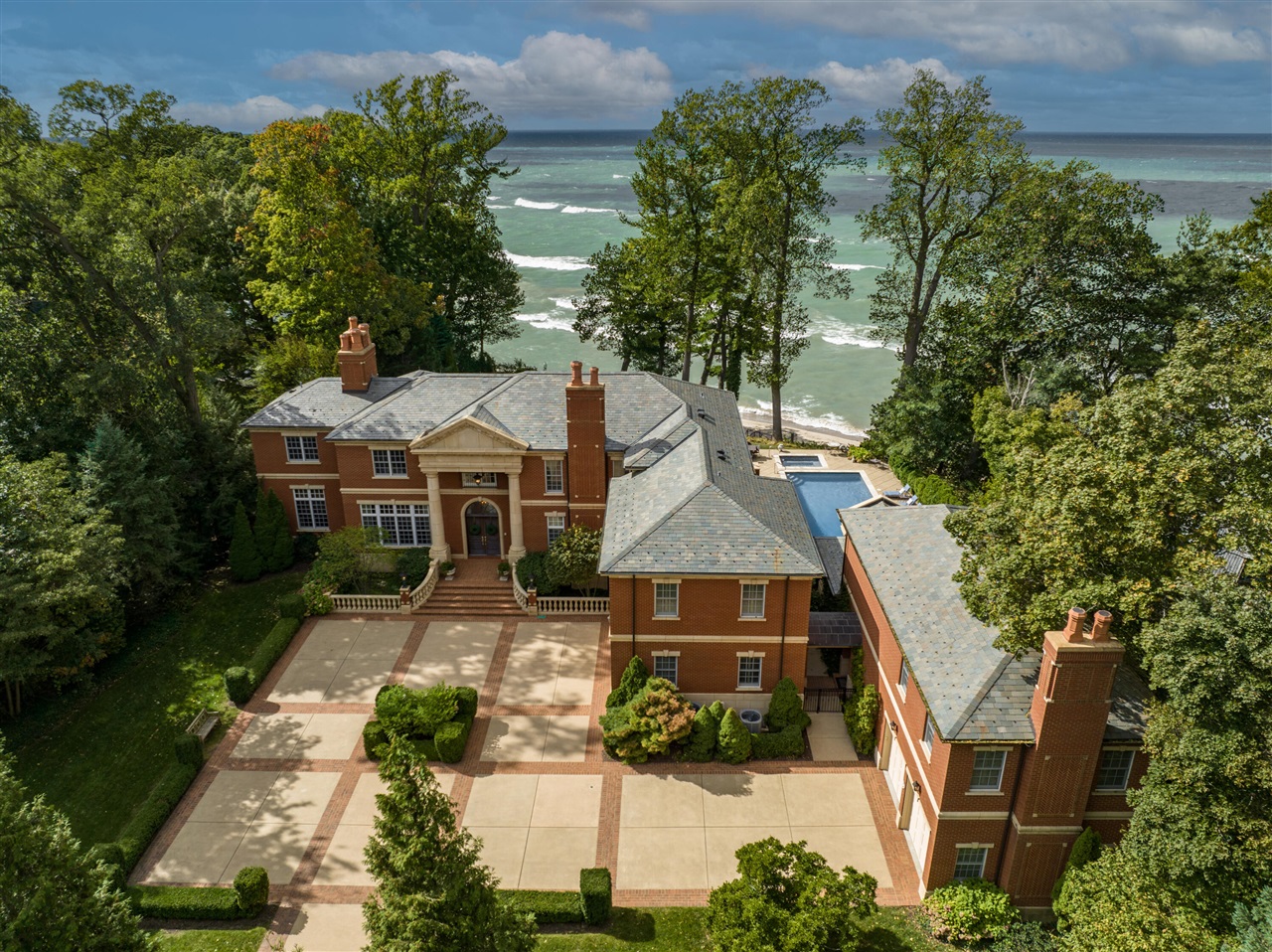 Magnificent 11,000+ sq. ft. stately Georgian estate situated on 148' of breathtaking Lake Michigan frontage. 40' swimming pool & spa overlooks huge sandy riparian beach. Unparalleled quality construction and state-of-the-art amenities in this 9 bedroom, 13 bath home. Richly paneled library & office with coffered ceilings, family room with wet bar & wine cellar, beautiful gallery with arched French doors opening on to a large stone terrace overlooking the lushly landscaped yard & lake. Primary suite with fireplace, 2 full baths, office/sitting room & screened porch. Enjoy cozy evenings in front of one of the 9 fireplaces. Amenities include a 4 bedroom attached guest house, radiant heated floors, home theater, exercise room, 4 car heated garage, lakefront fire pit & generator.