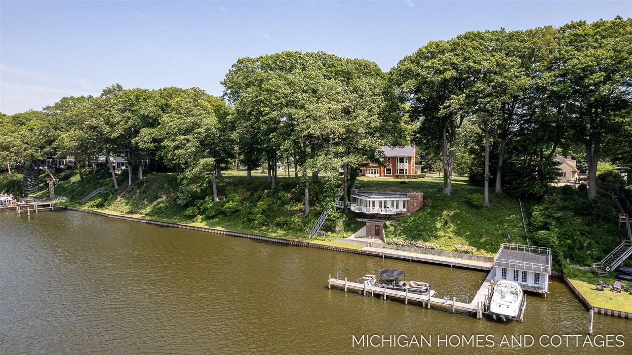 Nearly 400 feet of prime water frontage, and 2.7 acres of highly sought after Saugatuck land, this is truly the finest and most iconic remaining property on the water. 180-degree views both up and down river, as well as the beauty of your protected view across river of the Oxbow property, the location is ideal and just a short distance to downtown Saugatuck where you'll enjoy shops, restaurants, and entertainment that has drawn visitors to the area for decades. Upon pulling up to the estate on your circle driveway, you'll find the main home, a detached garage and separate carriage house.