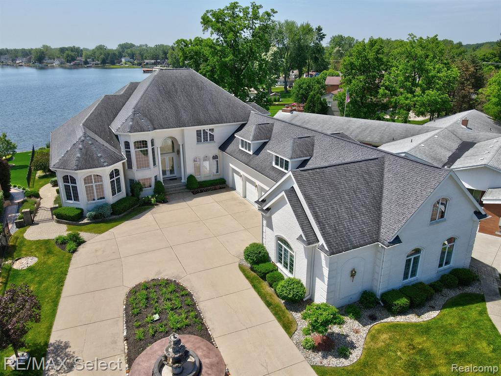 A rare opportunity to own this house on Lake Fenton. This is one of the largest and most exceptional homes on this Lake. It is currently being updated. It has 5 bedrooms, 4 full and 2 half baths, 6 plus car garages with tons of extra space for storage. It sits on 0.8 acres right in front of Lake Fenton Middle school with 100 ft. of lakefront on all-sports Lake Fenton. Upon entry, the living room impresses w/soaring ceiling & 2-story fireplace. Exploring this 7132+ sq. ft. home reveals a spacious kitchen w/seated island & premium, brand new smart appliances. Primary suite is complete w/fireplace, sitting area, vanities, & custom-built Walk-In Closets. Large dining room, office & den along w/2 separate living spaces with private entrances. The walkout LL includes a family room, wet bar, media room, exercise room, & access to the lake. Total living space is 11,000 sq. ft. The private setting, lake views, overall quality & custom features make this home an exceptional place to live.