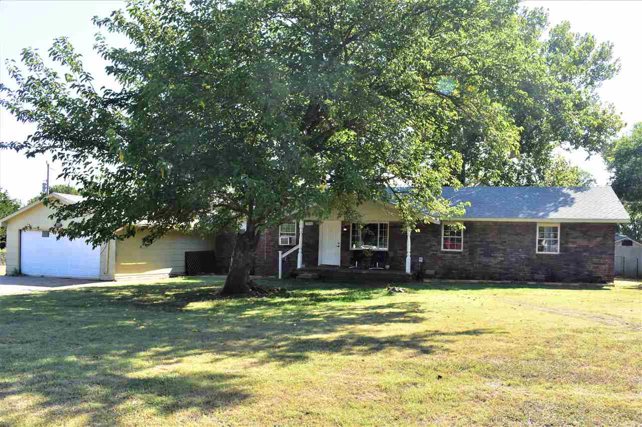 PRICE REDUCED!!! If you are looking for a house on 2.06 acres just outside of city limits in a quiet area, then you should consider this 4 bedroom property!! Spacious living room with fireplace. The patio door in the living room leads you out a good-sized patio and large backyard. The dining room is open to the kitchen. Three bedrooms and 1 bathroom are down the hall from the living room. The other bedroom, bonus room, bathroom and a separate room that can be use for crafts, office or whatever you wish, are located on the opposite side of the house. The laundry room will not disappoint as it is a good size located near the kitchen area. New hot water heater. One of the brick outbuildings is the well house and the other is for storage. There is rv hookups near the house with a 30amp electric, water and sewer. This property does allow outside space for chickens or goats if that is something that interest you. There is a private driveway to the backside of the property where a trailer or rv can be parked for possible rental income that has its own electric pole, sewer, driveway, carport and shares the well water with the primary house. The property is being sold “As Is”. Just a little TLC and you can make it your own.
