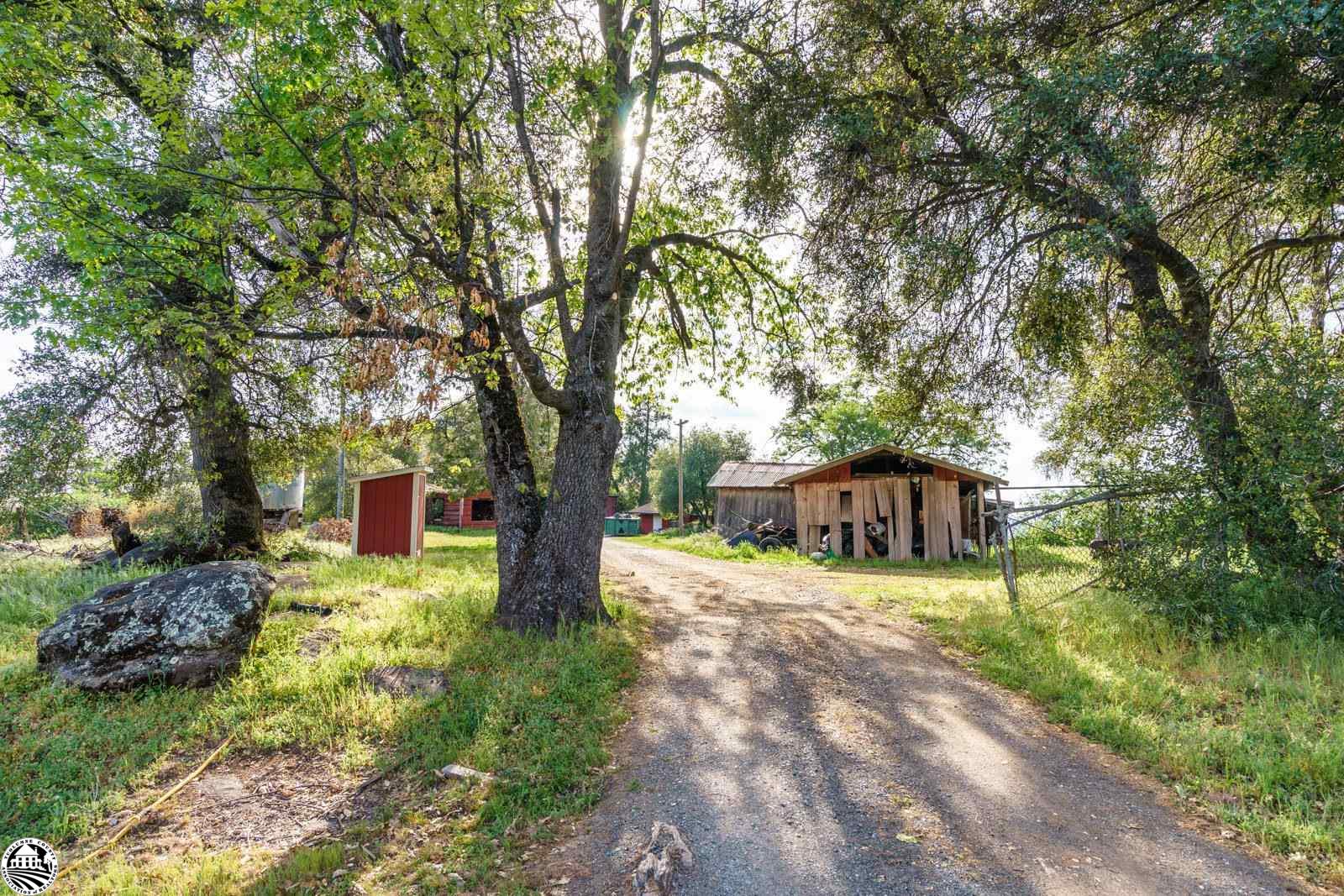 Investors take a look! Priced to sell project home on nearly 7 1/2 total acres with two parcels (separate APN's). Adjacent lot is 3.928 acres being sold together with the main lot of 3.5 acres. Build on one and live on the other. Gorgeous views from behind the home on the main lot and privacy as well. Lots of usable outdoor space all within a mile to town yet feel like you're in the country. The home has 5 permitted bedrooms and 2 bathrooms plus bonus areas (don't forget to look downstairs). Great for a remodel/rebuild with septic, electric and well with a new pump ready to go! Several outbuildings including a one car garage and workshop space. Bring your ideas and create something wonderful here. As is sale. Call your favorite agent today and come see in person.