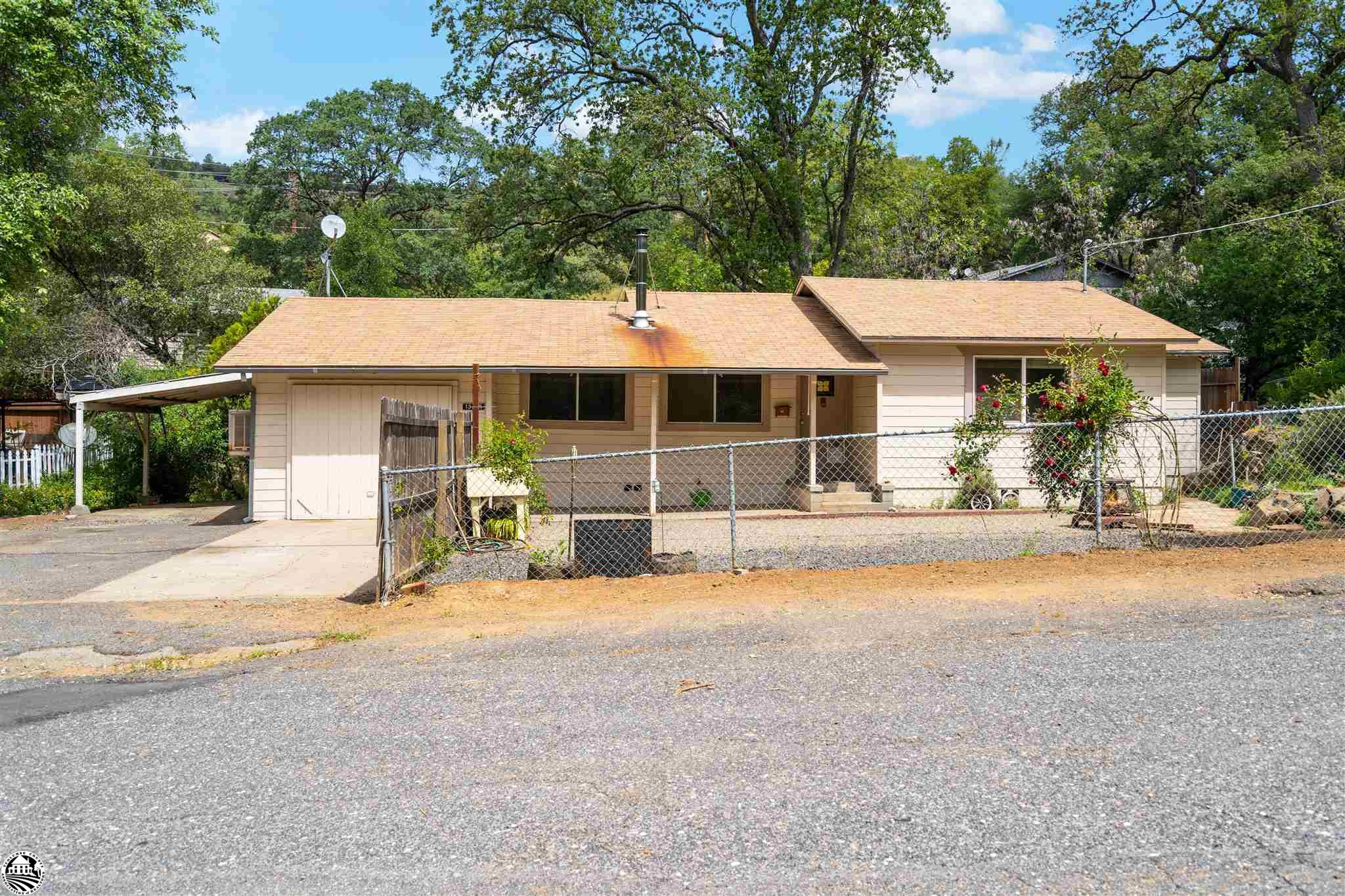 Great opportunity on this Value Priced Diamond in the Rough in The Sierra Foothills. There are 2 bedrooms, 1 full bath and a garage conversion/bonus room in this level entry home on  .27 acres within 2 plus hours of most bay area locations.  You’ll really love the interesting rock garden at the front of the fenced yard and the fact that the home is on well water and district sewer. There are mature shade trees, a pear tree... no partridge on the property, an herb garden, a fire pit, a spacious side garden with a storage shed, a level parking area with a RV parking place. Nine minutes from historic downtown Sonora. Splash in Pinecrest lake in the summertime and ski at Dodge Ridge in the winter just minutes away.