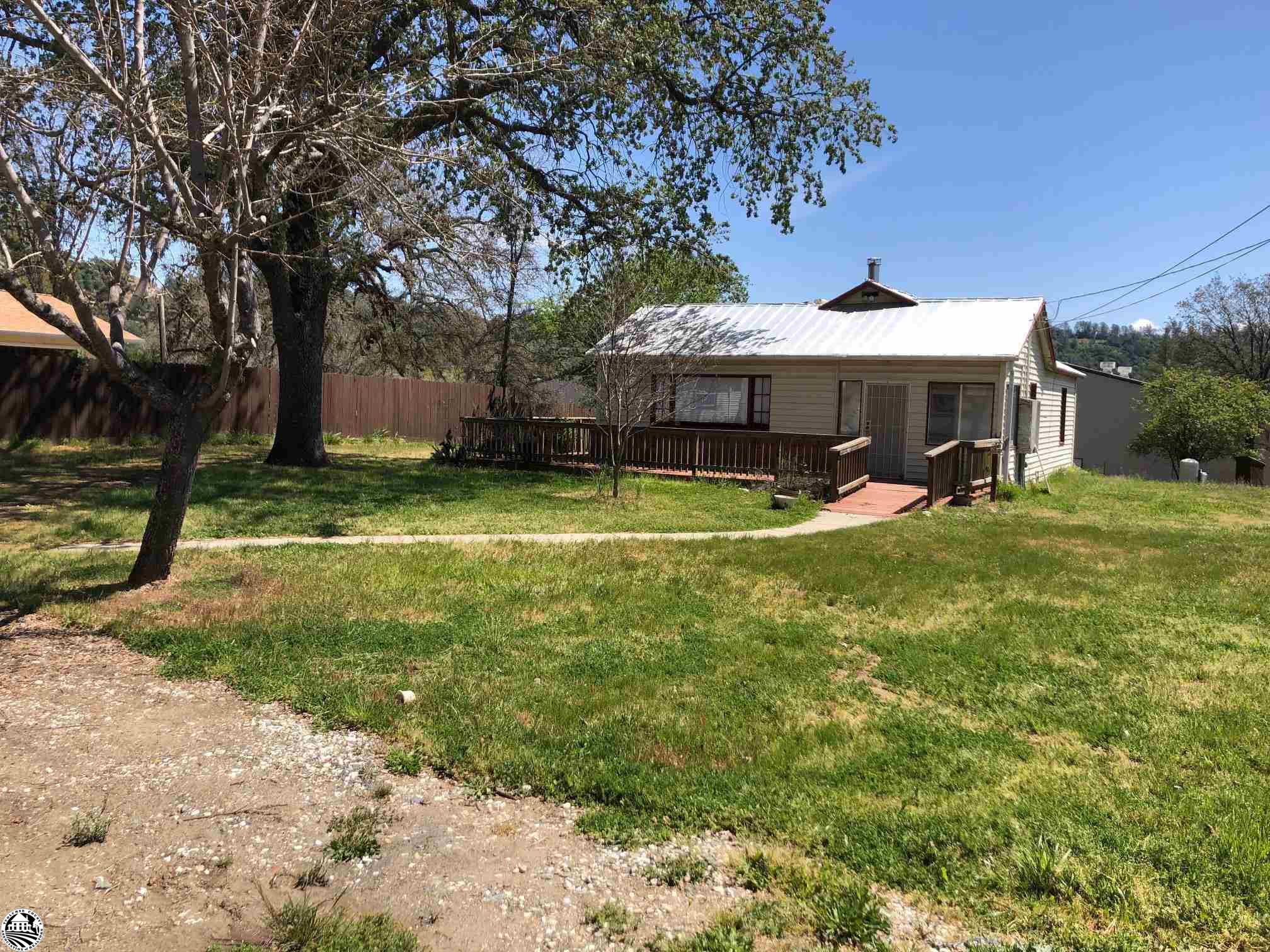 CHARMING 2 BEDROOM 2 BATH HOME ON OVER 1/2 ACER WITH SEPARATE OVERSIZED 2 CAR GARAGE. PROPERTY ZONED FOR COMMERCIAL BUSINESS IN PRIME AREA. LOTS OF OPTIONS.  HOME,  BUSINESS ,  RENTAL OR BOTH.
