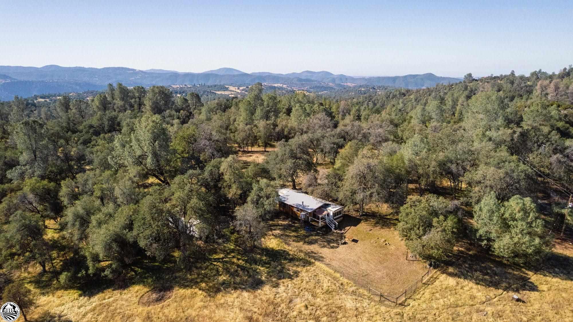 Opportunity on desirable fenced horse property! Can't find your dream home build it on over 10 peaceful acres in the Foothills of Tuolumne County~Or~ bring your TLC move into Modular home with an addition, wood burning stove and enjoy the peaceful setting and views from your back deck. Close to Yosemite two hours from Bay Area. As is sale.