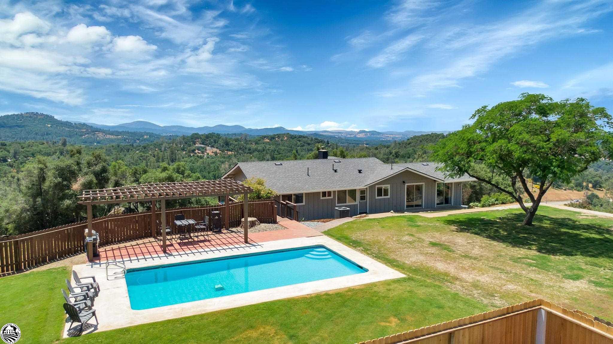 Open house - Sunday, June 11th from 12:00pm - 2:00 pm.  Buyers to show qualification proof before entering property.   Poolside Sunsets with Breathtaking Panoramic Views! 19960 Tin Man Lane is a 2439sq.ft. forever home with 2 master suites, 2 more guest bedrooms, 3 full baths, a 4+ car garage with a mancave area, a perfect for wine cellar storage basement room and all situated on 10.77 private acres. Lots of remodeling and updates with a newer kitchen, roof with seamless gutters, flooring, central heat and AC, an Aqua-Tech well filtration system, 4 year old decks and railings and a new pool filter and sweep. There is fresh paint inside and out and almost all new windows. Most electrical and plumbing has been updated and the resurfaced pool with a shade pergola is so inviting you will never want to leave. The all electric kitchen is equipped with stainless steel appliances, granite counter tops and an eating bar for gathering at mealtime. There are huge picture windows in the spacious living room to capture the valley views, sunsets and city lights. Perfect for holiday gatherings to cozy up in front of the wood burning fireplace insert . You with love the entry level master suite with a large remodeled bath tile and stone shower. It is 1 of 2 master bedrooms, so a good setup for multi family or generational clean mountain living. The property has been graded with a nice spot for a horse setup, the driveway has a newer seal coat and there is a fenced garden area. The detached shop building is about 700sq. ft. and just right for an additional dwelling unit conversion and there is lots of level equipment or RV parking.  This very commuter convenient homestead is about 2.5 hours from most Bay Area locations. Just minutes to Yosemite National Park, Pinecrest Lake Resort, Dodge Ridge Ski Resort, New Melones Reservoir, Don Pedro Lake, Columbia Airport and State Park Trails, Restaurants, Shopping and Relaxing under the stars.