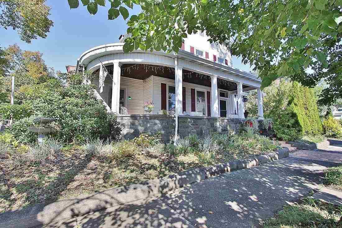 This house is 200 feet above sea level. Newly staged, stocked and professionally prepped as a turnkey boutique bed-and breakfast by the waterfront! Owner is including the business name to this income producing property. Stunning Victorian perched on a hill walkable to the Kingston waterfront is a structural masterpiece with seasonal mountain views with an intimate quality. Featuring high curved, cove and coffered ceilings adorned with crystal chandeliers. The home is graced with gleaming hand laid herringbone oak floors and careful craftsmanship architecture. A rare Victorian with untouched original historic elements with matching white marble fireplaces, French pocket doors, and built in bookshelves/cabinets. There is even a dumbwaiter! In addition there are saloon doors, bathrooms on each floor, and a total of four bedrooms. Once an operative bed and breakfast for over 20 years, create your own potential income property with a separate side entrance leading to an en-suite. A sanctuary in the heart of Kingston offering a wrap around porch, private backyard with a patio, firepit, and spacious driveway. Newer updates include a hot water heater, rubber roof, new range, new refrigerator, and granite kitchen countertops. Minutes from NYS thruway, restaurants, coffee shops, art museums and just under 2 hours to NYC,  experience the best of Kingston in paradise.  Property also falls in the the Highly Desirable RT, Rondout District zone, allowing for Mixed use commercial/residential, live/work, multi family, retail, restaurant etc.