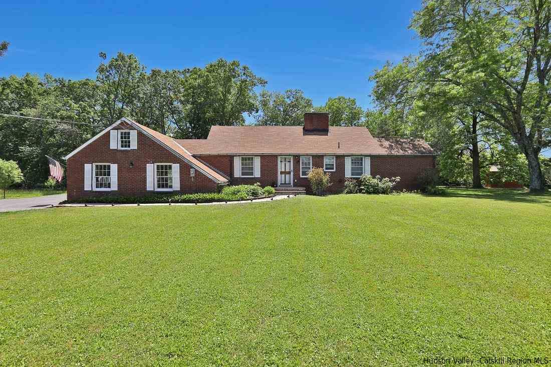 This charming, well maintained brick ranch located in the Town of Ulster is perfect for  relaxing  and entertaining with a fire pit and ample outdoor space. Bright eat-in kitchen with a corner fireplace and upgraded brushed nickel appliances (2019). Huge living room with gorgeous brick fireplace to cozy up next to and a large picture window that faces the backyard. A sweeping lawn to the West where you can take in incredible sunsets. Enjoy dinner in your dining room with access to the back yard that leads to the firepit, which is great for entertaining. Down the hallway you will find three bedrooms which are generously sized, and another room that can be used as an office or another bedroom. Ceramic tile and hardwood bamboo floors are throughout. Solid pine six panel doors throughout, lush landscape, wildlife; this house has all of that and so much more to offer.