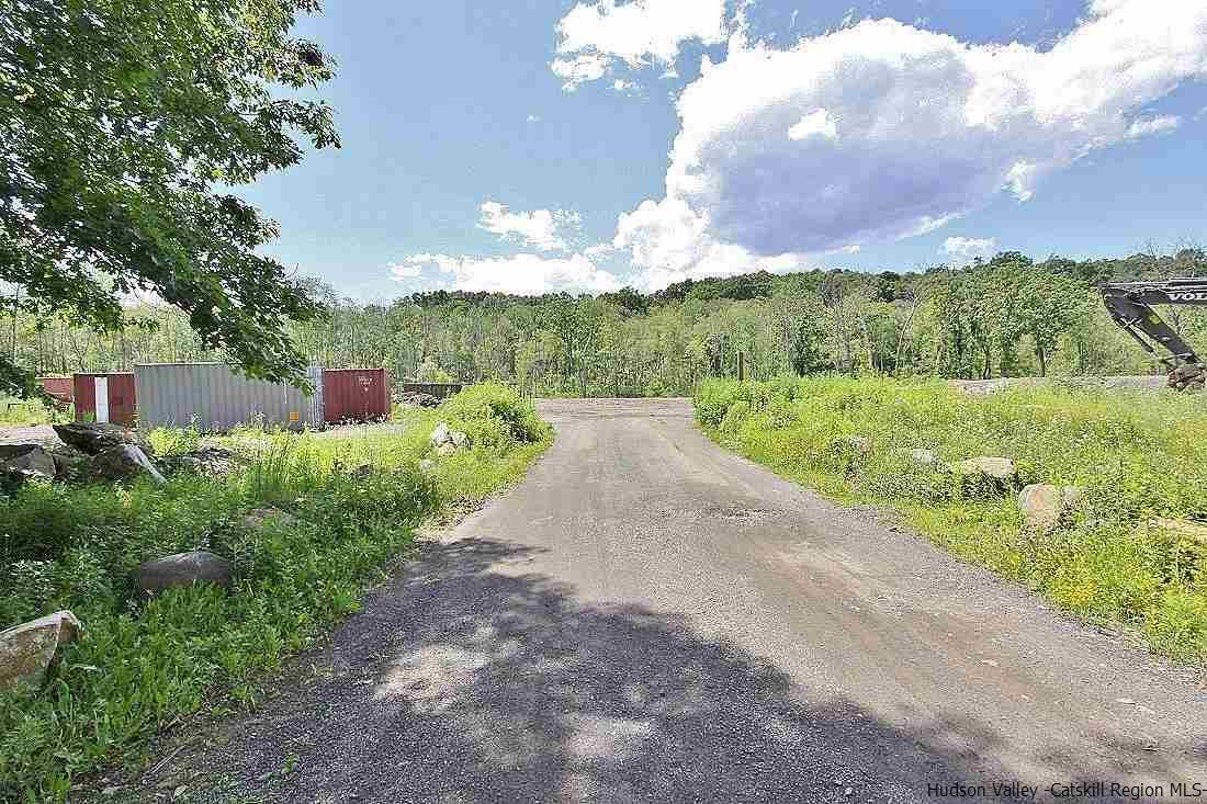 Commercial improved land on Busy Route 9W in Ulster Park, halfway between Downtown Kingston and New Paltz.  The 5.64 acre parcel is zoned LI-Light Industrial with permitted uses to include Agricultural, Building trades/Contractors, Farms, Equipment storage yards, Business offices, Manufacturing, Wineries, Craft breweries/Distilleries, Lumber/Wood products, Transportation businesses, Fuel dealers and many more, see associated doc's for full list of uses and guidelines.  The owner has a prior approved Site plan for a 4,460 building to show an idea of how the lot may lay out when developed.  Traffic count is 12,293 daily.